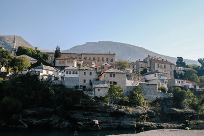 Buildings in town against clear sky