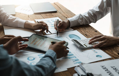 Midsection of business colleagues working at office