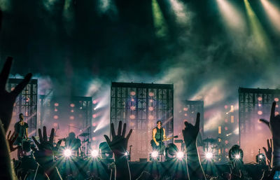 People enjoying music concert at night