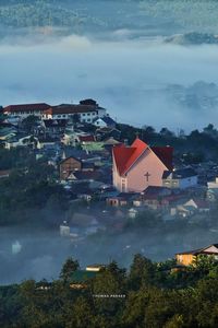 High angle view of houses and buildings against sky