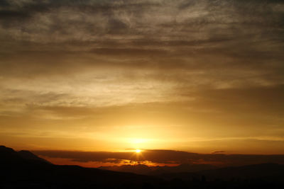Scenic view of silhouette mountains against sky during sunset