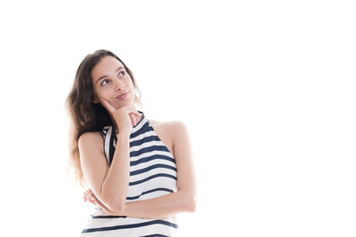 Portrait of beautiful young woman against white background