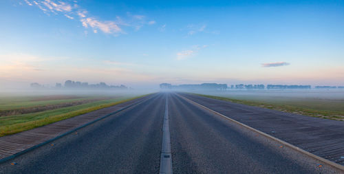 Road amidst landscape against sky during sunset