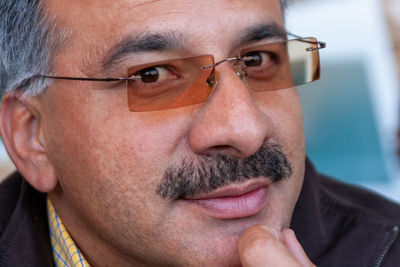 Close-up portrait of man wearing eyeglasses