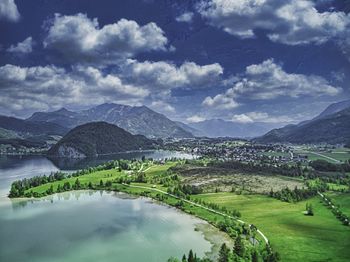 Scenic view of lake and mountains against sky