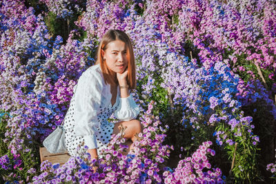 Young woman on purple flowering plants