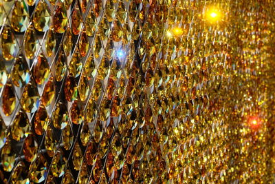 Full frame shot of illuminated lights hanging at night