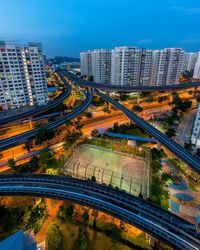 High angle view of city street and buildings against sky