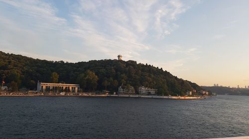 Scenic view of sea and buildings against sky