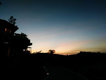 Silhouette buildings against sky during sunset