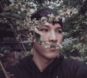 Close-up portrait of young woman with flowers