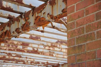 Low angle view of rusty brick wall