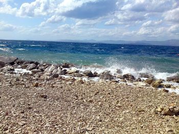 Scenic view of sea against cloudy sky
