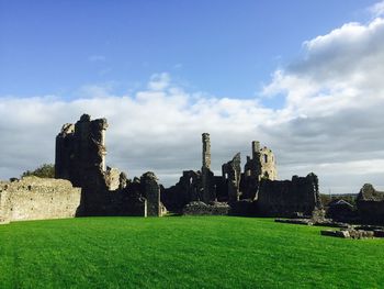 Abandoned castle on field against sky