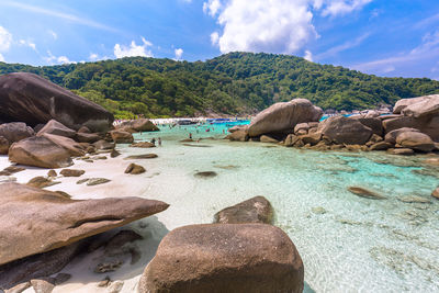 Rocks on beach against sky