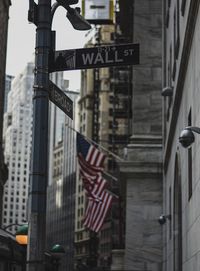 Low angle view of flags and buildings in city