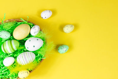 Directly above shot of christmas decorations on yellow background