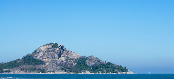 Scenic view of sea against clear blue sky