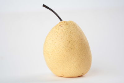 Close-up of fruit over white background