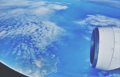 Low angle view of cropped car against blue sky