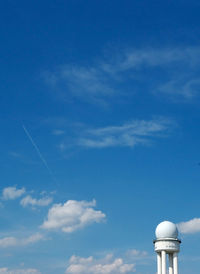 Low angle view of vapor trail against blue sky