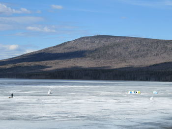 Scenic view of lake and mountains against sky