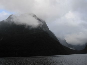Scenic view of sea and mountains against sky