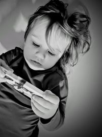 Side view of girl holding smartphone 