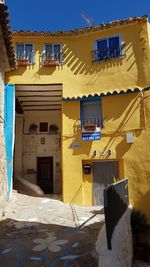 Low angle view of yellow buildings against sky