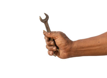 Close-up of man holding hands against white background