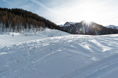 Scenic view of snow covered mountains against sky