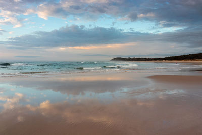 Scenic view of beach against sky during sunset