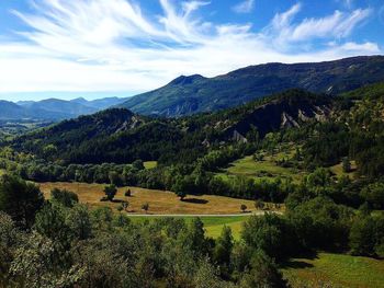 Scenic view of mountains against cloudy sky