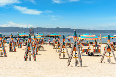 People at beach against sky