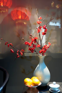 Close-up of red rose in vase on table