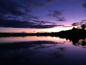 Scenic view of lake against romantic sky at sunset