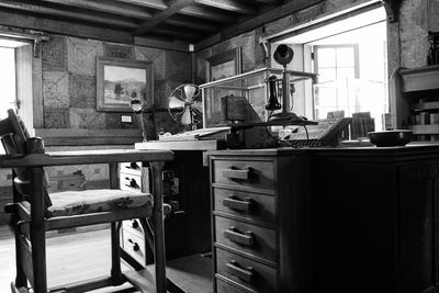 Empty chair by table in old-fashioned office