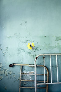 Low angle view of rusty metal against wall