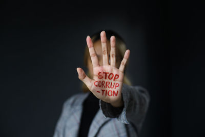 Close-up of human hand against black background
