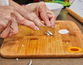 Cropped hand of person preparing food