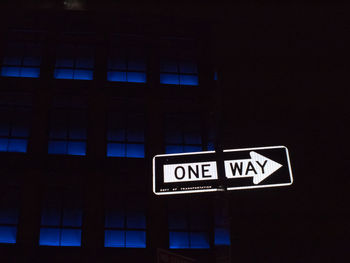 Close-up of road sign at night