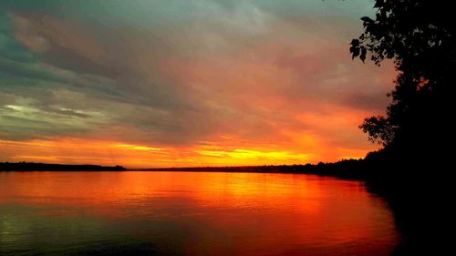 Scenic view of lake against orange sky