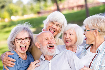 Smiling friends enjoying at park