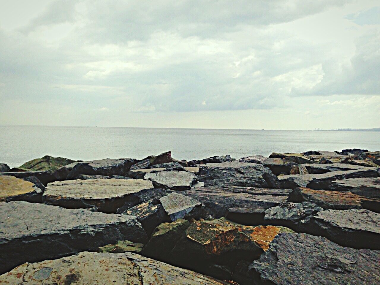 water, sea, sky, horizon over water, tranquil scene, tranquility, scenics, cloud - sky, rock - object, beauty in nature, nature, stone - object, cloudy, cloud, beach, shore, idyllic, day, outdoors, remote