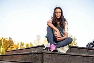 Low angle view of young woman standing on staircase