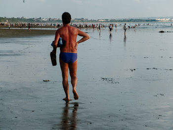 Full length of woman standing on beach