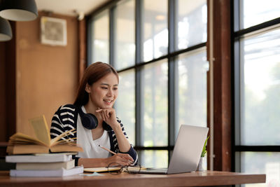 Businesswoman using laptop at office