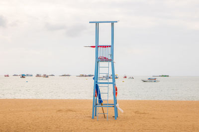 Lifeguard hut on beach against sky