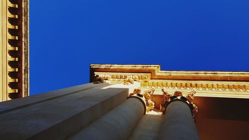 Low angle view of historical building against blue sky