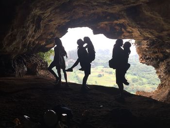 Silhouette friends in cave